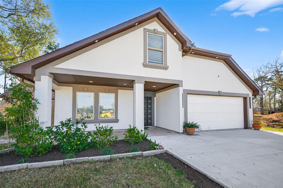 Front exterior of a new home in , Conroe, TX, highlighting curb appeal (Image 1). Front exterior of a new home in , Conroe, TX, highlighting curb appeal (Image 1).