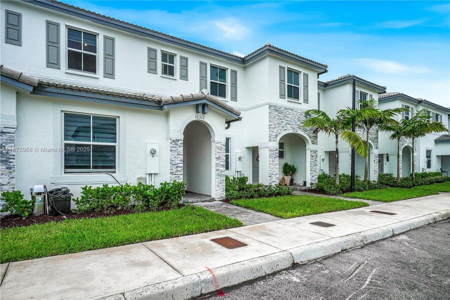 Front exterior of a new home in , Homestead, FL, highlighting curb appeal (Image 18).