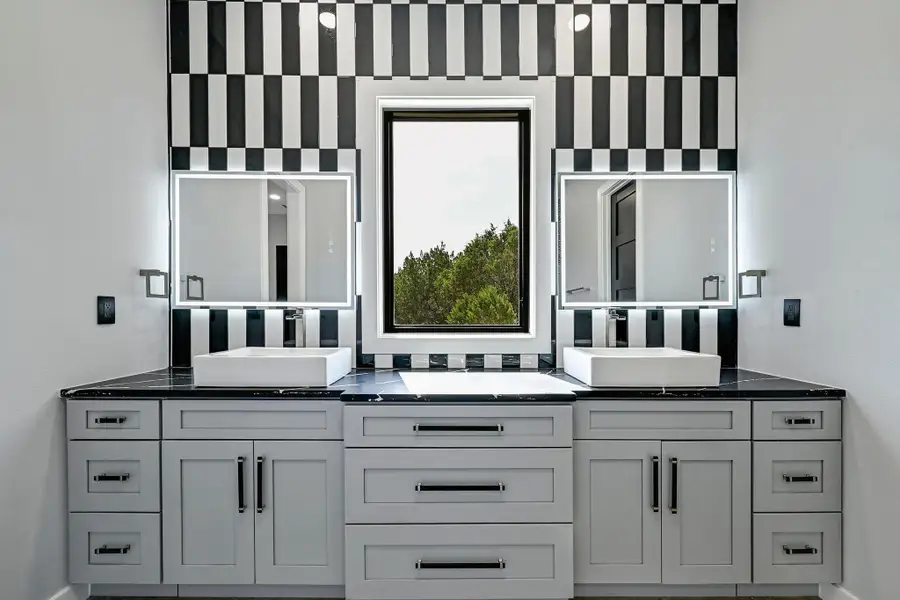 Featuring three custom designed luxury designer bathrooms including this private primary ensuite bath with a dual vanity. Featuring three custom designed luxury designer bathrooms including this private primary ensuite bath with a dual vanity.