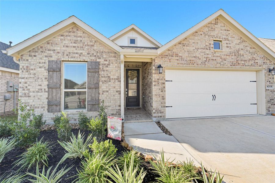 This home features a charming brick exterior with rustic shutters and a welcoming front porch. This home features a charming brick exterior with rustic shutters and a welcoming front porch.