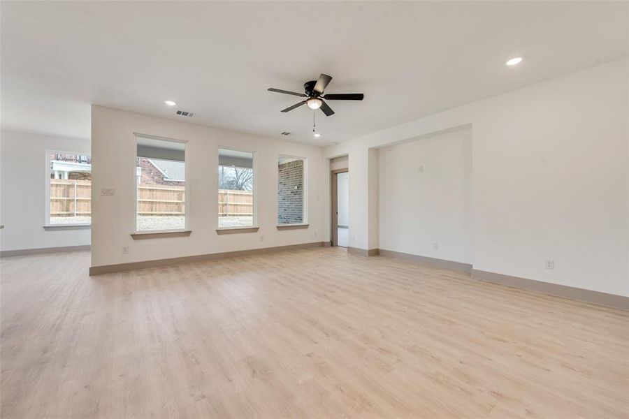 Unfurnished room with ceiling fan and light hardwood / wood-style flooring