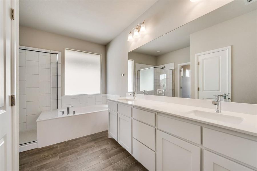 Primary Bathroom featuring vanity and independent shower and double sink