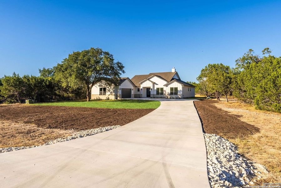 Front exterior of a new home in , Bandera, TX, highlighting curb appeal (Image 24).