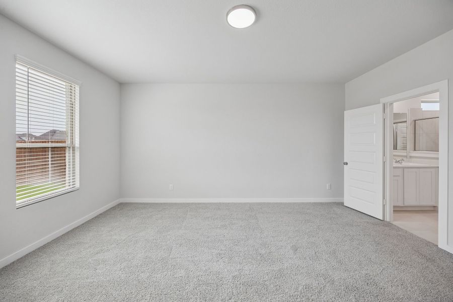 Primary Suite in the Masters home plan by Trophy Signature Homes – REPRESENTATIVE PHOTO