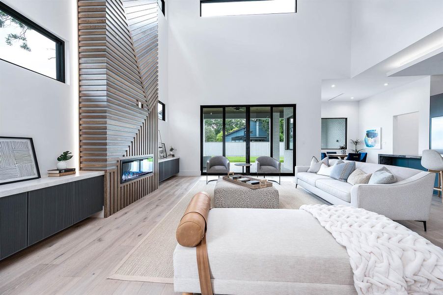 Living room with custom 12 foot glass sliding doors that seamlessly connect the indoor space to the backyard.