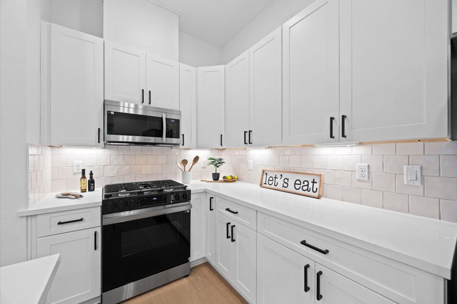 Beautiful kitchen island with plenty of space for food prep and extra sitting area.
