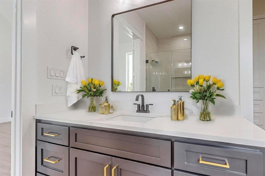 Bathroom featuring hardwood / wood-style flooring, a shower with door, and vanity