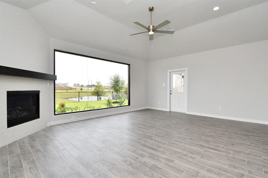 Another view of family room with upgraded picture window. Sample photo of completed home with similar floor plan. Actual colors and selections may vary.