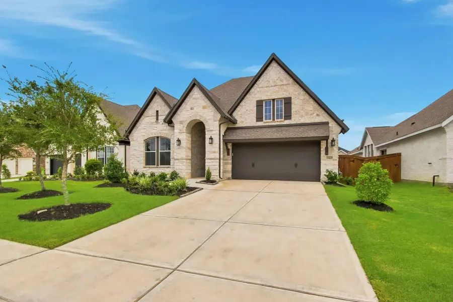 Charming brick home featuring a classic gabled roof, manicured landscaping, and a generously sized driveway. The attractive exterior creates a warm first impression and enhances the home’s curb appeal.