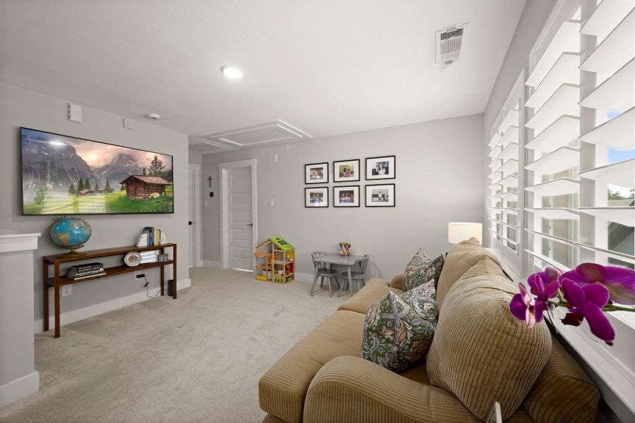 At the top of the stairs, an open flex space adds versatile room for work, play, or study. At the top of the stairs, an open flex space adds versatile room for work, play, or study.