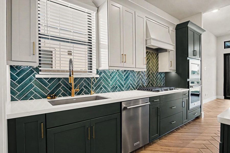 Beautiful details in the kitchen include the Blanco single basin sink and upgraded matte, gold hardware. Beautiful details in the kitchen include the Blanco single basin sink and upgraded matte, gold hardware.