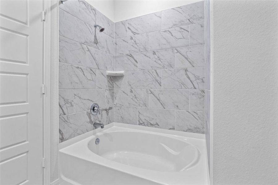 Pictured here is the large tub and shower combination with tile surround.