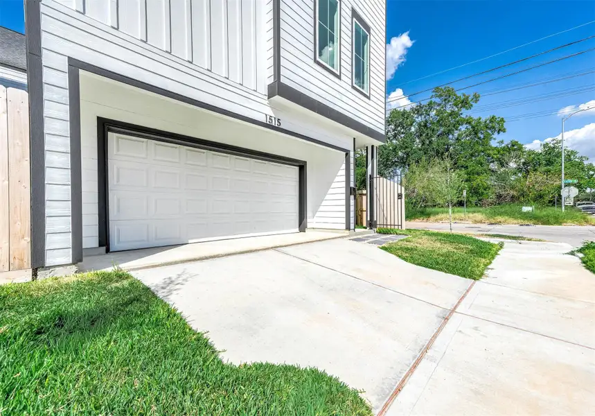 Private two-car garage with a wide driveway and contemporary exterior finishes, offering both convenience and polished curb appeal.