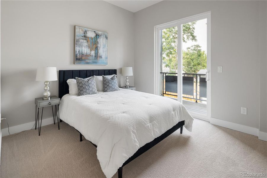 Primary Bedroom with Sliding Doors to A Private Deck