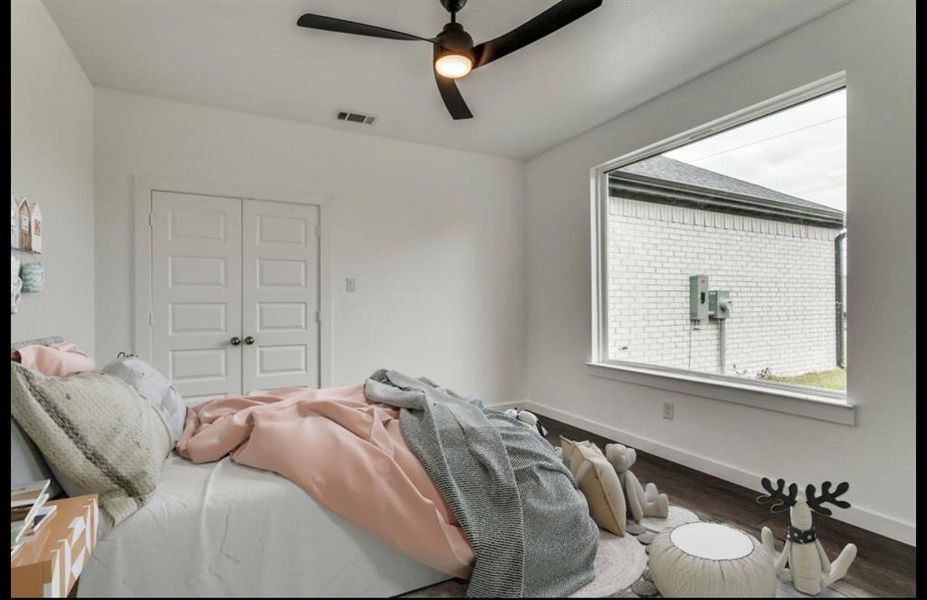 Bedroom featuring hardwood / wood-style flooring, a closet, and ceiling fan