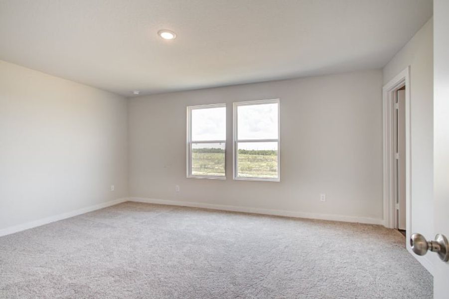 A room with a window and carpet. A room with a window and carpet.