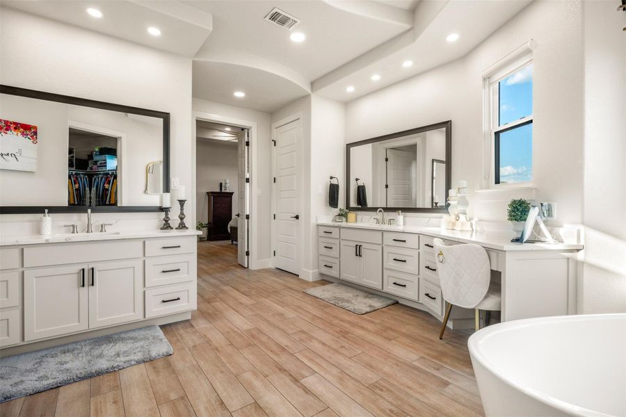 Bathroom featuring hardwood / wood-style flooring, vanity, and a tub to relax in Bathroom featuring hardwood / wood-style flooring, vanity, and a tub to relax in