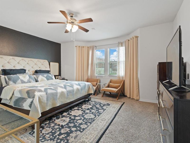 Carpeted bedroom with ceiling fan