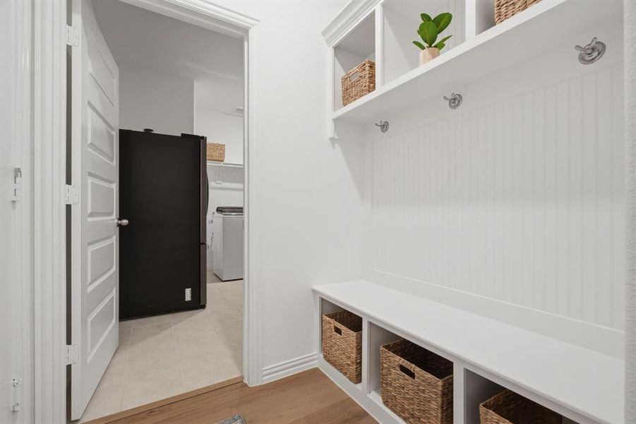Built-in mudroom/drop zone with bench, hooks, cubbies, and extra storage keeps everyday life organized. Conveniently located near the laundry room, this is a buyer-loved feature in 905 Bluebell St in Princeton, TX.