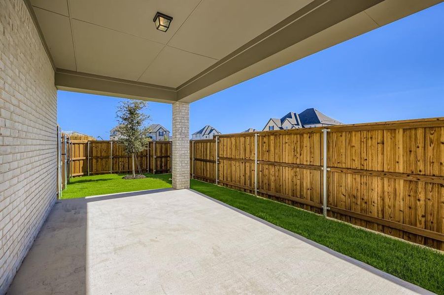 Fenced backyard featuring a patio area Fenced backyard featuring a patio area