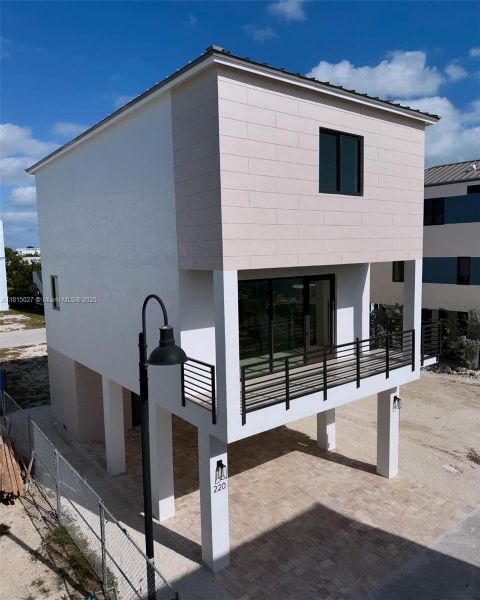 Front exterior of a new home in , Key Largo, FL, highlighting curb appeal (Image 2). Front exterior of a new home in , Key Largo, FL, highlighting curb appeal (Image 2).