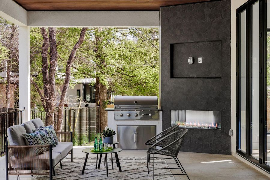 The outdoor living area is anchored by a built-in grill and fireplace, designed for elevated, year-round entertaining. The outdoor living area is anchored by a built-in grill and fireplace, designed for elevated, year-round entertaining.
