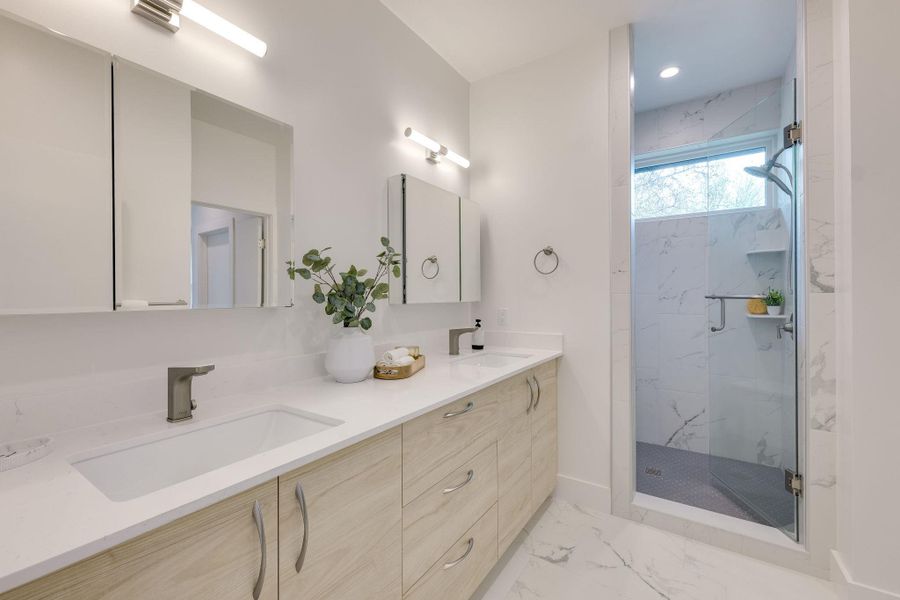 Great storage in the primary bath with large walk-in shower & dual vanities.