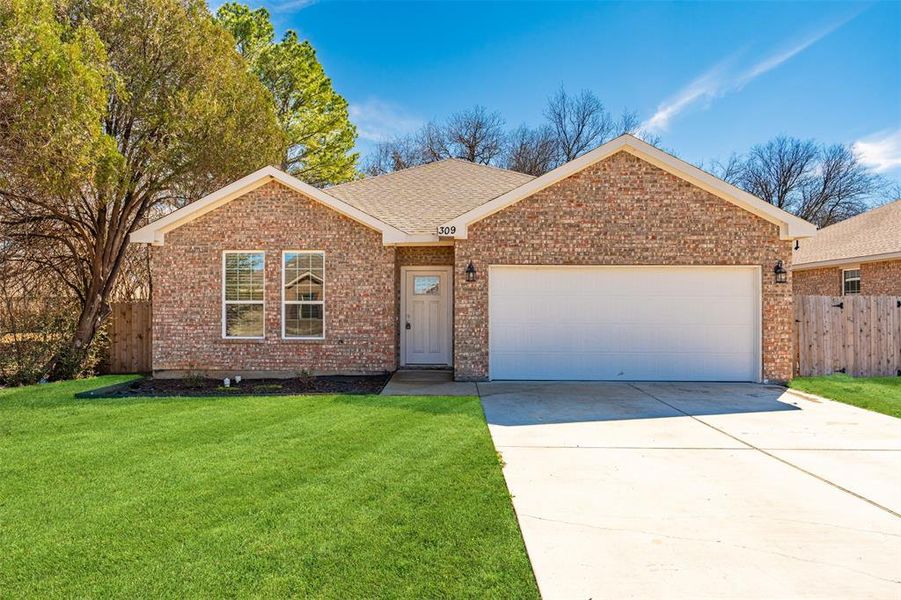 Ranch-style home featuring an attached garage, a front yard, concrete driveway, and brick siding