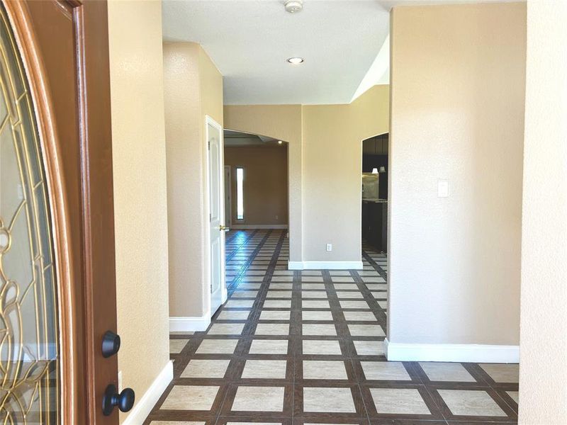 Hall with dark tile patterned floors