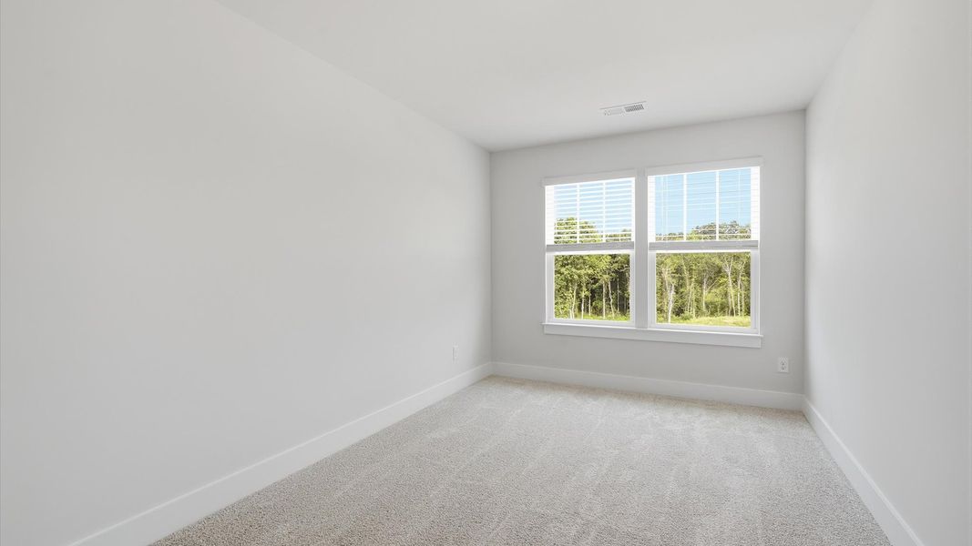Highly functional bedroom with large windows, carpeted flooring, and tasteful finishes throughout at Marion Square Highly functional bedroom with large windows, carpeted flooring, and tasteful finishes throughout at Marion Square