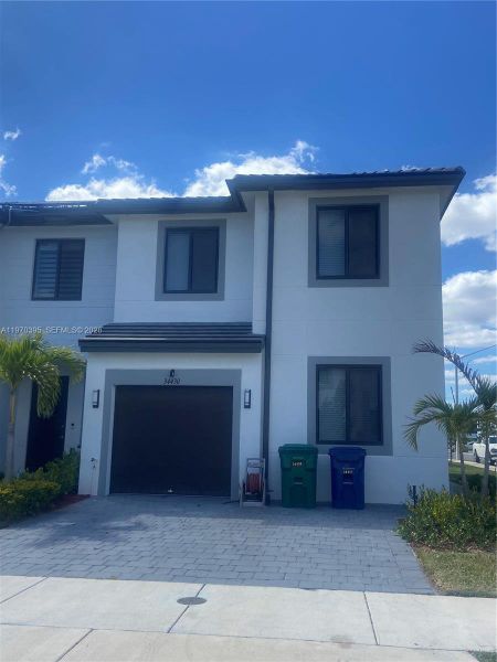 Front exterior of a new home in , Homestead, FL, highlighting curb appeal (Image 9).