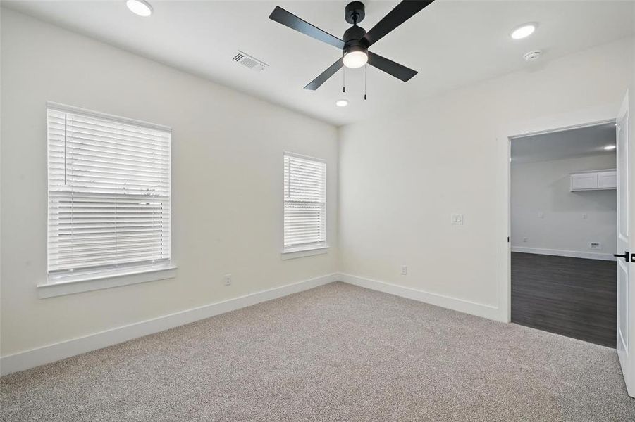 Carpeted spare room with baseboards, ceiling fan, visible vents, and recessed lighting Carpeted spare room with baseboards, ceiling fan, visible vents, and recessed lighting