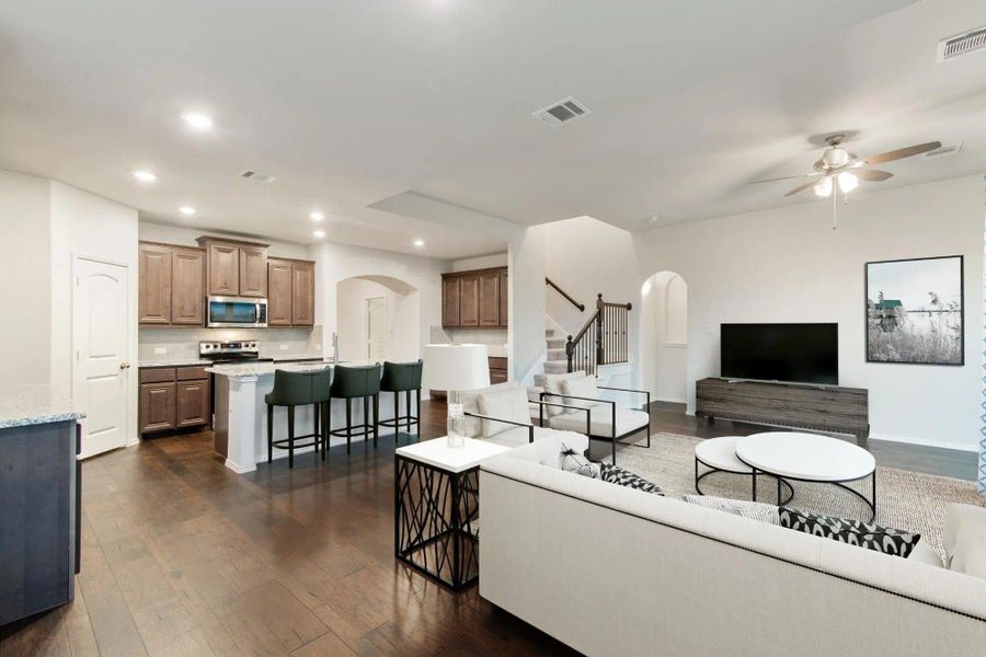 Family Room & Kitchen | Concept 2844 at Hunters Ridge in Crowley, TX by Landsea Homes