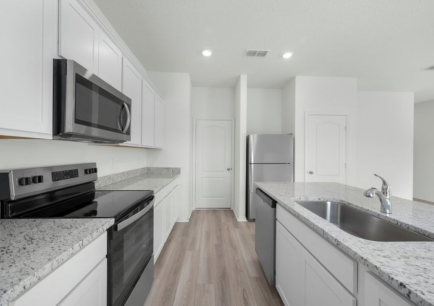 The kitchen is filled with stainless steel appliances