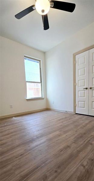 Empty room with french doors, ceiling fan, and hardwood / wood-style floors