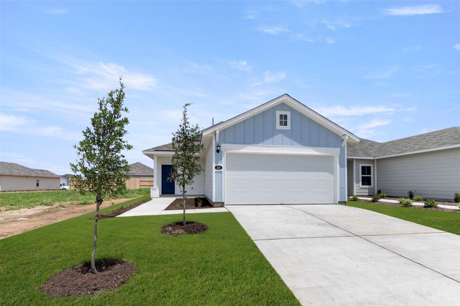 Single story home with board and batten siding, an attached garage, a front lawn, concrete driveway, and a shingled roof Single story home with board and batten siding, an attached garage, a front lawn, concrete driveway, and a shingled roof