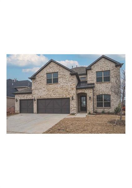 View of front of property with a garage