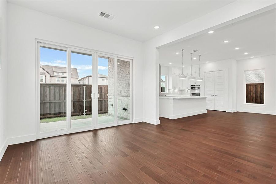 Unfurnished living room featuring dark hardwood / wood-style floors