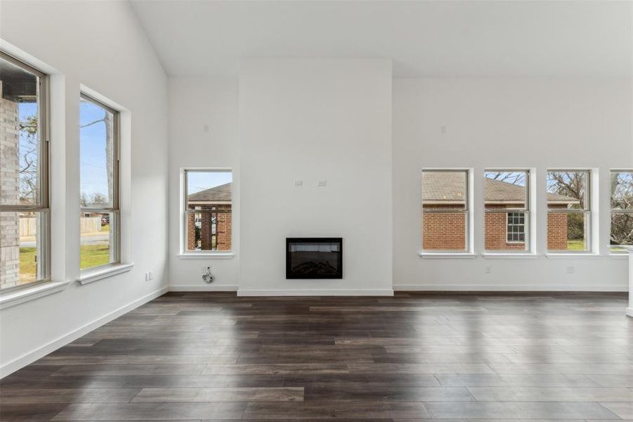 Unfurnished living room with dark wood-type flooring