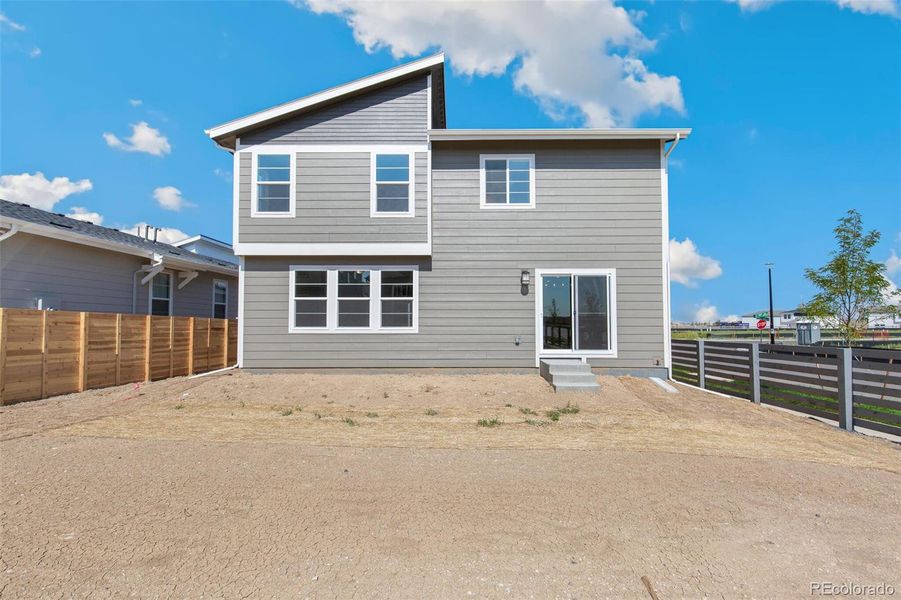 Front exterior of a new home in Legato, Commerce City, CO, highlighting curb appeal (Image 1).