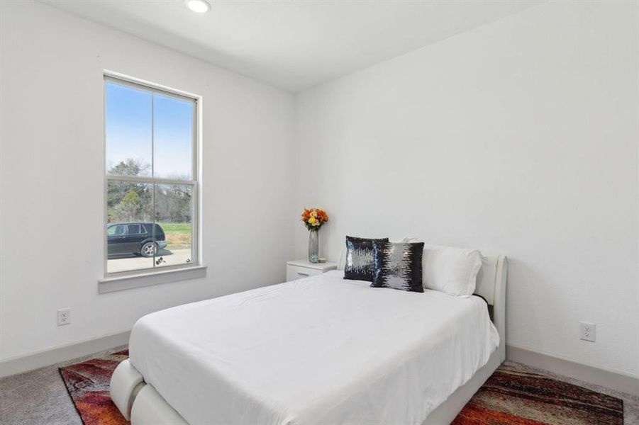 Carpeted bedroom with baseboards and recessed lighting Carpeted bedroom with baseboards and recessed lighting