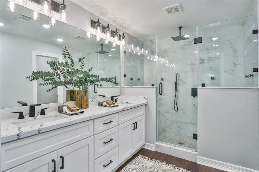 Character and Charm With Modern Style. Gorgeous primary bathroom with Quartz countertops and olid wood cabinetry with Dovetail drawers.