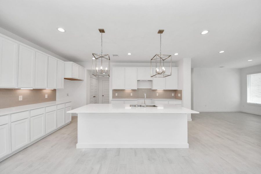 This kitchen is by far any chef’s dream! This spacious kitchen features high ceilings, light stained wood cabinets, granite countertop, SS appliances, modern tile backsplash, recessed lighting, extended counter space, granite kitchen island with double sink, and space for breakfast bar, and a walk-in pantry all overlooking your huge family room. Sample photo of completed home with similar floor plan. Actual colors and selections may vary. This kitchen is by far any chef’s dream! This spacious kitchen features high ceilings, light stained wood cabinets, granite countertop, SS appliances, modern tile backsplash, recessed lighting, extended counter space, granite kitchen island with double sink, and space for breakfast bar, and a walk-in pantry all overlooking your huge family room. Sample photo of completed home with similar floor plan. Actual colors and selections may vary.