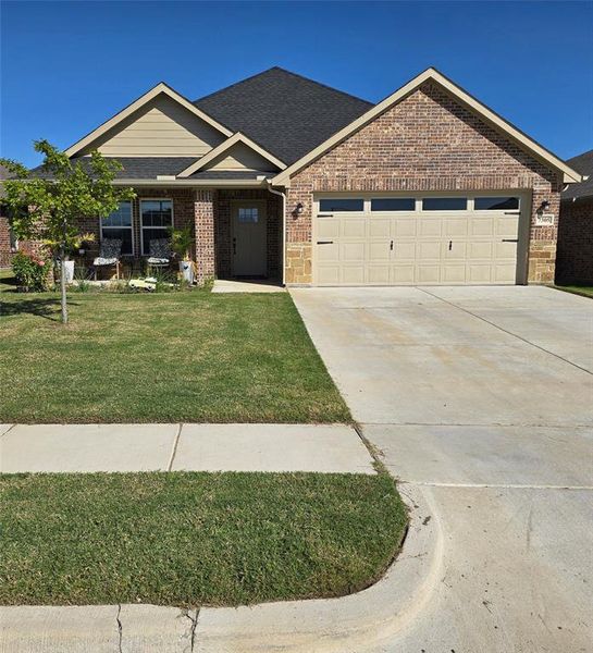 View of front of house with a front lawn and a garage