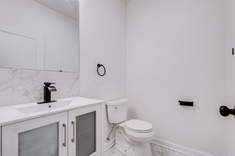 Bathroom featuring tile patterned floors, toilet, and vanity