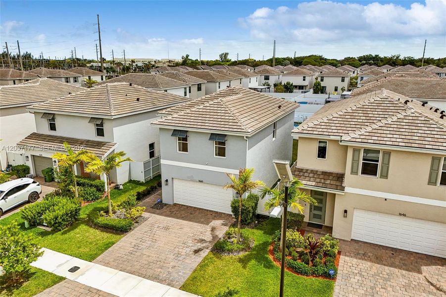 Front exterior of a new home in Messina Place, Homestead, FL, highlighting curb appeal (Image 26).