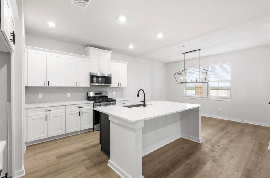 Chef-inspired kitchen with granite countertops, white cabinets, and stainless steel appliances. Chef-inspired kitchen with granite countertops, white cabinets, and stainless steel appliances.