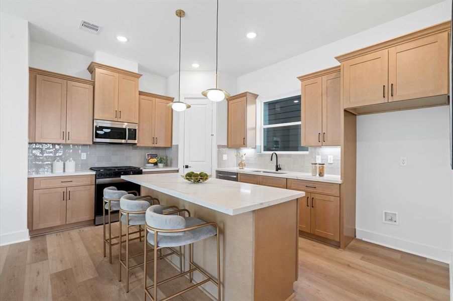 This chef's kitchen has plenty of counter space and stainless steel appliances.