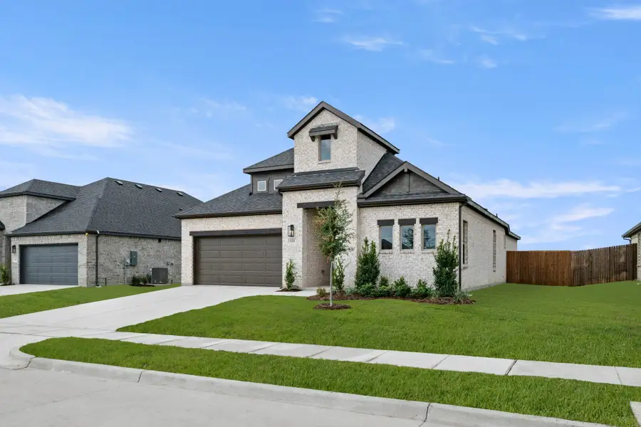 Front exterior of a new home in Vista Point, Grandview, TX, highlighting curb appeal (Image 2). Front exterior of a new home in Vista Point, Grandview, TX, highlighting curb appeal (Image 2).