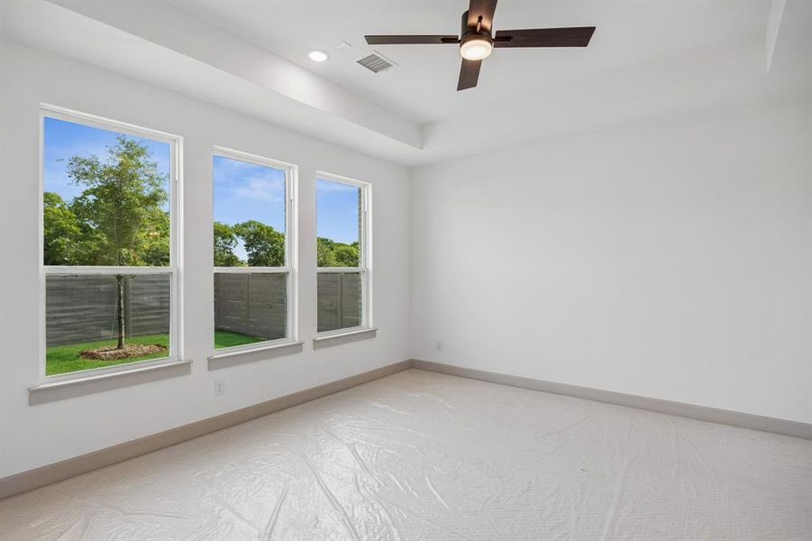 High ceilings, plush carpet and a wall of windows create a peaceful and relaxing owner's suite.